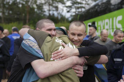 epa12171806 Ukrainian prisoners of war (POWs) embrace following a prisoner swap at an undisclosed location in Ukraine, 12 June 2025. This is the second stage of the return of seriously wounded and seriously ill soldiers, Ukrainian President Volodymyr Zelensky wrote in his official Telegram channel. The agreement on a POW exchange was reached after recent...