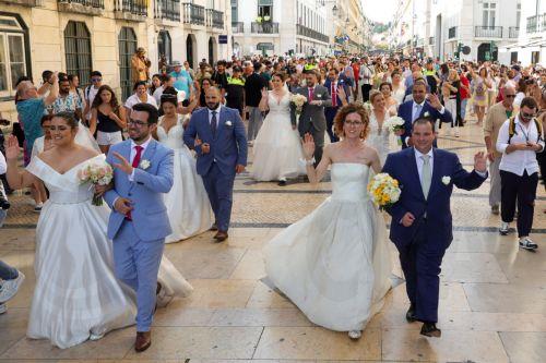 epa12171887 Newly wed couples parade after they got married during a traditional ceremony dubbed the St. Anthony's Weddings at the Cathedral of Lisbon, Portugal, 12 June 2025. Several couples got married during the traditional event which its name refers to Saint Anthony of Padua who was born in Lisbon and cosidered a matchmaker and patron of young brides. ...