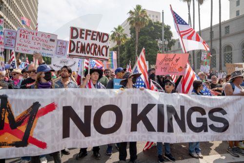 epaselect epa12176646 Demonstrators hold banners during a 'No Kings Day' protest in Los Angeles, California, USA, 14 June 2025. The No Kings protests are a series of demonstrations organized for 14 June, against Trump's policies and actions during his second presidency, coinciding with the US Army's 250th Anniversary Parade and US President Trump's 79th...