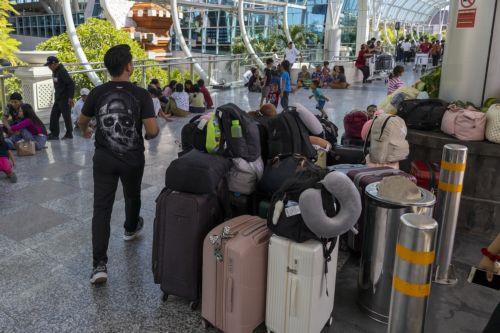 epa12182598 People wait for their flight at Ngurah Rai International Airport in Bali, Indonesia, 18 June 2025. Numerous flights to and from Bali were canceled following the eruption of Mount Lewotobi Laki-Laki in East Nusa Tenggara on 17 June 2025. The volcano sent a massive ash plume soaring 10 km high.  EPA/MADE NAGI