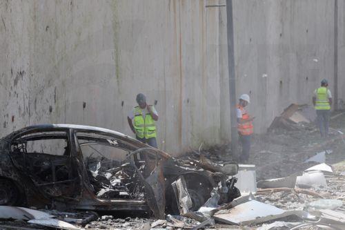 epa12184821 Israeli emergency workers stand near a damaged cars among debris at the site of an Iranian missile strike in a residential area in Ramat Gan, central Israel, 19 June 2025. Israel's military stated Iran launched a barrage of ballistic missiles at Israel overnight. Magen David Adom (MDA), Israel's national emergency services, reported dozens of...