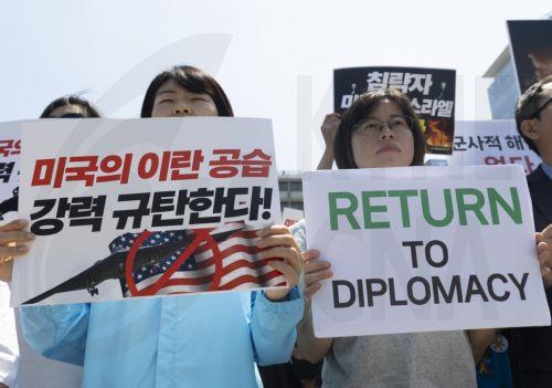 epa12192035 Protesters shout slogans and hold placards during a rally against Israeli and US attacks on Iran, outside the US Embassy in Seoul, South Korea, 23 June 2025. The US bombed three of Iran's nuclear sites in Fordow, Natanz, and Isfahan while Israel and Iran have been exchanging fire since Israel launched strikes across Iran on 13 June 2025 as part...