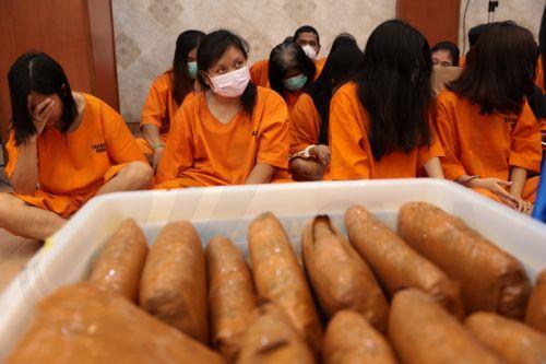 epa12192125 Alleged drug dealers sit in front of evidence during a press conference on the disclosure of a drug distribution network at the Directorate General of Customs and Excise office in Jakarta, Indonesia, 23 June 2025. The Indonesian National Narcotic Agency, together with Indonesian Customs, have succeeded in arresting 285 drug suspects with...