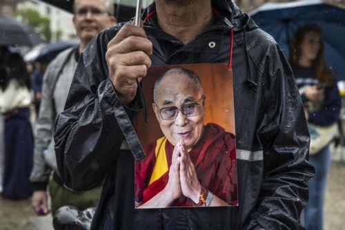 epa12220378 People gather on Dam Square to celebrate the 90th birthday of the Dalai Lama, in Amsterdam, the Netherlands, 06 July 2025. The Tibetan Buddhist spiritual leader, born in 1935, turns 90 years old on 06 July 2025.  EPA/DINGENA MOL