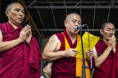 epa12220386 People dressed in traditional Tibetan monastic robes address members of the public gathered on Dam Square to celebrate the 90th birthday of the Dalai Lama, in Amsterdam, the Netherlands, 06 July 2025. The Tibetan Buddhist spiritual leader, born in 1935, turns 90 years old on 06 July 2025.  EPA/DINGENA MOL