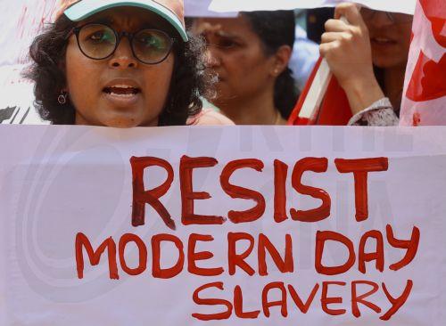 epa12226107 Members of the All India United Trade Union Centre (AIUTUC), Centre of Indian Trade Unions (CITU), and other trade union organisations hold placards and shout slogans during a nationwide general strike, or 'Bharat Bandh', to oppose the 'anti-worker, anti-farmer, and anti-national' pro-corporate policies in Bangalore, India, 09 July 2025. Over a...