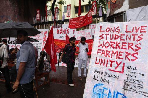 epa12226200 Left union activists shout against the central government during a nationwide strike in Kolkata, eastern India, 09 July 2025. The nationwide strike was organized by 10 trade unions in protest against four labour laws.  EPA/PIYAL ADHIKARY