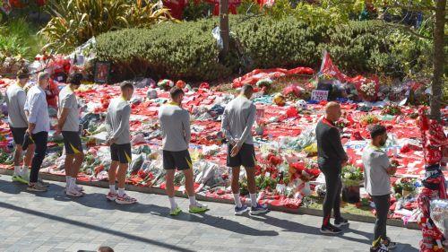 epa12232260 Liverpool players with head coach Arne Slot (2-R, black tracksuit) view tributes to late Portuguese soccer player Diogo Jota at Anfield, the home of Liverpool FC, in Liverpool, Britain, 11 July 2025. Jota died in a car accident in Spain together with his brother Andre Silva on 03 July 2025.  EPA/PETER POWELL