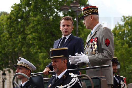 epa12237078 French President Emmanuel Macron stands in the command car with Chief of Staff of the French Armed Forces (CEMA) Thierry Burkhard during the annual Bastille Day military parade in Paris, France, 14 July 2025. France celebrates its national holiday, or Bastille Day, annually on 14 July to commemorate the storming of the Bastille fortress in 1789....