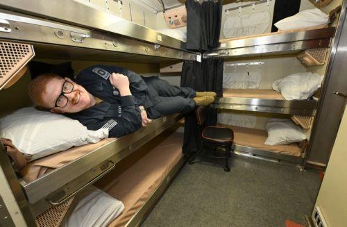 epa12271815 Sonar Technician Submarine First Class Dylan Prater rests in a bunk bed in the crew’s quarters aboard the USS Ohio, the first Ohio-class submarine to dock at the Port of Brisbane, Australia, 30 July 2025. The USS Ohio, a nuclear-powered guided-missile submarine with 150 crew members, is visiting Brisbane.  EPA/DARREN ENGLAND NO ARCHIVING...
