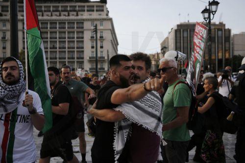 epa12275623 A Palestinian living in Greece reacts after being verbally attacked by a woman supporting Israel during a rally against Israel's ongoing operations in the Gaza Strip, in central Athens, Greece 31 July 2025.  EPA/YANNIS KOLESIDIS