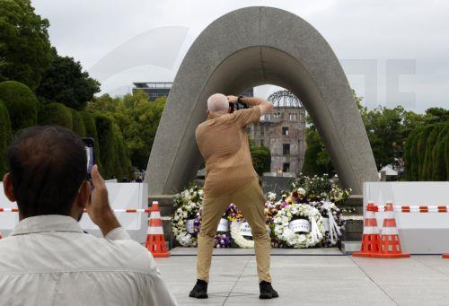 epa12282795 Tourists take pictures of the Memorial Cenotaph and the Atomic Bomb Dome at Peace Memorial Park in Hiroshima, western Japan, 04 August 2025. On 06 August 2025, Japan will mark the 80th anniversary of the bombing of Hiroshima. In 1945 the United States dropped two nuclear bombs over the cities of Hiroshima and Nagasaki on 06 and 09 August...