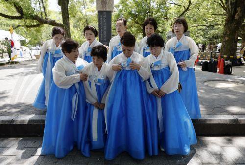 epa12283782 Members of the Korean Residents Union in Japan gather after attending a ceremony at the 'Monument in Memory of the Korean Victims of the A-bomb' located in the Peace Memorial Park in Hiroshima, western Japan, 05 August 2025. 06 August 2025 will mark the 80th anniversary of the bombing of Hiroshima. In 1945, the United States dropped two nuclear...
