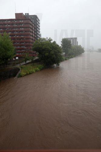 epa12293092 The Shirakawa river is seen at high level in Kumamoto, southwestern Japan, 11 August 2025. Kyushu island was hit by continuous heavy rainfall due to a stagnant front, causin the Japan Meteorological Agency issued a special heavy rainfall warning in the Kumamoto Prefecture area. Torrential rain triggered floods, landslides and the cancellation of...