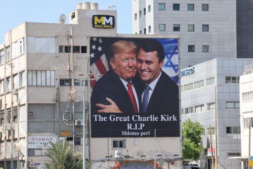 epaselect epa12370776 A billboard shows an image of US President Donald Trump (L) embracing US conservative political activist Charlie Kirk to honor Kirk following his fatal shooting, in Tel Aviv, Israel, 12 September 2025. Kirk, 31, was shot dead while speaking at Utah Valley University on 10 September 2025.  EPA/ABIR SULTAN EPA