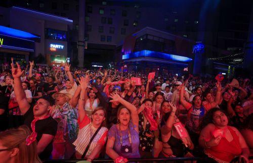 epa12394610 People watch the broadcast of Bad Bunny's concert at the T-Mobile District in San Juan, Puerto Rico, 20 September 2025. Bad Bunny concluded his musical residency, 'No Me Quiero Ir De Aqui: Una Mas,' at the Coliseo de Puerto Rico with an additional and 31st show, turning the event into a public celebration. The concert was broadcast across...