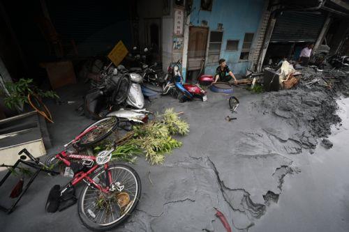 epa12401273 A man looks at the the damage as floods recede in the aftermath of Super Typhoon Ragasa in Guangfu Township, Hualien County, Taiwan, 24 September 2025. At least 14 people have died, 32 were injured and more than 150 are missing in the eastern county after a barrier lake in the mountains overflowed and inundated the township during the typhoon,...