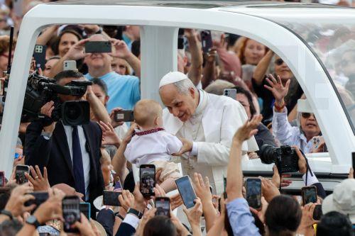 epa12401299 Pope Leo XIV blesses a baby as he arrives to lead the weekly general audience in Saint Peter's Square, Vatican City, 24 September 2025.  EPA/GIUSEPPE LAMI