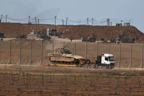 epa12442732 An Israeli military truck carrying APCs leaving the Gaza Strip after the Trump announcement on the Israel-Hamas agreement on the first phase of a Gaza peace plan, 09 October 2025. US President Donald Trump announced that Israel and Hamas have agreed to the first phase of a Gaza peace plan, which includes the release of Israeli hostages and...