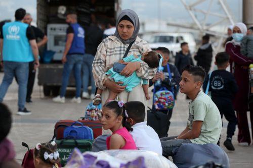 epa12454710 Syrian refugees gather as they prepare to return home to Syria in Beirut, Lebanon, 15 October 2025. The Lebanese government, in coordination with the United Nations High Commissioner for Refugees (UNHCR), conducted the fifth phase of the organized departure of Syrian refugees back to their homeland. According to Lebanese General Security, over...