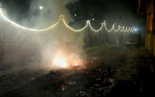 epa12468322 People light sparklers and crackers during Diwali celebrations near New Delhi, India, 20 October 2025. Diwali, the Hindu festival of lights symbolizing the victory of good over evil and marking Lord Rama's return to Ayodhya after 14 years of exile, is celebrated with fireworks. However, the celebrations severely impact Delhi's air quality, with...