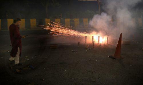 epa12468329 People light sparklers and crackers during Diwali celebrations near New Delhi, India, 20 October 2025. Diwali, the Hindu festival of lights symbolizing the victory of good over evil and marking Lord Rama's return to Ayodhya after 14 years of exile, is celebrated with fireworks. However, the celebrations severely impact Delhi's air quality, with...