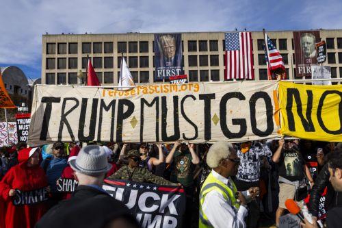 epa12506394 Protesters march during a 'Trump Must Go Now' rally one year after Trump was elected to a second term in Washington, DC, USA, 05 November 2025. Democrats delivered sweeping victories against Trump and Republicans in general elections on 04 November, winning in New York, New Jersey and Virginia.  EPA/JIM LO SCALZO
