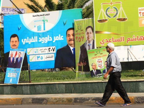 epa12510555 An Iraqi man walks past election campaigning posters ahead of the parliamentary elections in Baghdad, Iraq, 07 November 2025. Iraq is preparing to hold legislative elections on 11 November 2025.  EPA/CEERWAN AZIZ