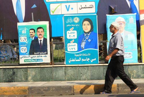 epa12510556 An Iraqi man walks past election campaigning posters ahead of the parliamentary elections in Baghdad, Iraq, 07 November 2025. Iraq is preparing to hold legislative elections on 11 November 2025.  EPA/CEERWAN AZIZ