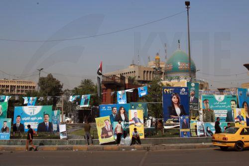 epa12510565 Iraqis pass past election campaigning posters ahead of the parliamentary elections in Baghdad, Iraq, 07 November 2025. Iraq is preparing to hold legislative elections on 11 November 2025.  EPA/CEERWAN AZIZ