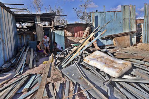 epa12511561 People stand near the rubble of a house in El Cobre, Santiago de Cuba province, Cuba, 07 November 2025. The five Cuban provinces severely affected by Hurricane Melissa on 29 October are beginning to gradually restore services, although authorities have warned that the damage is extensive and that normalization will take time.  EPA/ERNESTO...