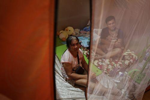 epa12513649 Residents of a flood-prone district stay inside a modular tent at an evacuation center set up in anticipation of Typhoon Fung-Wong in Quezon City, Metro Manila, Philippines, 09 November 2025. According to the Philippine Atmospheric, Geophysical, and Astronomical Services Administration (PAGASA), the typhoon is projected to be 100 kilometers...