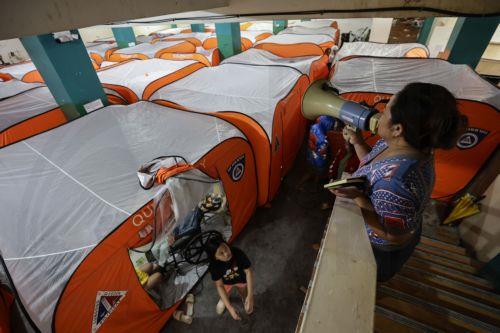 epa12513651 A village assistance personnel makes an announcement at an evacuation center set up in anticipation of Typhoon Fung-Wong in Quezon City, Metro Manila, Philippines, 09 November 2025. According to the Philippine Atmospheric, Geophysical, and Astronomical Services Administration (PAGASA), the typhoon is projected to be 100 kilometers northeast of...