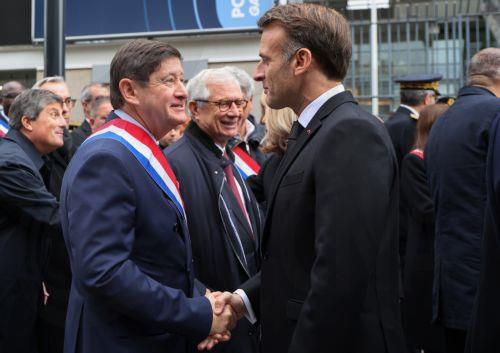 epa12522869 French President Emmanuel Macron (C-R) shakes hands with President of the Socialist group in the Senate Patrick Kanner (C-L)during a ceremony outside the Stade de France stadium, in tribute to victims of the November 2015 Paris attacks, in Saint-Denis northern suburb of Paris, France, 13 November 2025. Ten years ago 130 people were killed, and...