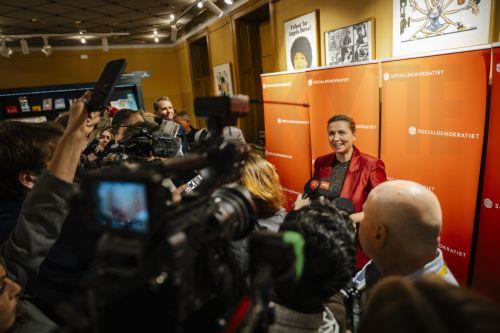 epa12534799 Denmark Prime Minister Mette Frederiksen (R) holds a doorstep after her speech during the Social Democrats' election party at the Workers' Museum in Copenhagen, Denmark, 18 November 2025. Denmark is holding Municipal and regional elections on 18 November.  EPA/EMIL NICOLAI HELMS  DENMARK OUT