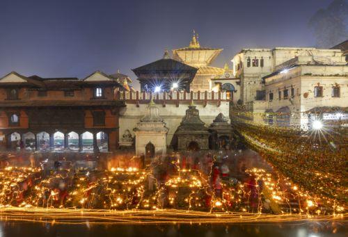 epa12534862 Nepalese devotees release oil lamps at the Bagmati River in memory of deceased family members as they observe the Balachaturdashi festival at Pashupati temple in Kathmandu, Nepal, 19 November 2025. Thousands of people from all over the country have gathered at the Pasupati temple to light oil lamps on the Bagmati River in honor of their departed...