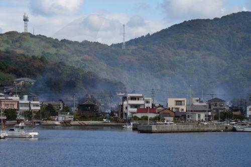 epa12534906 Smoke rises from the site of a fire that burned residential buildings and shops Saganoseki district of Oita, southwestern Japan, 19 November 2025. A fire broke out in the Saganoseki district on the evening of 18 November 2025, damaging more than 170 buildings. According to Oita Prefecture government, a man in his 70s is unaccounted for while 175...