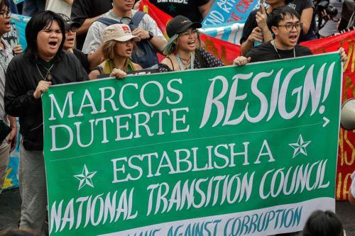 epa12539491 Protesters hold a banner calling for the resignation of Philippine President Ferdinand Marcos Jr. and Vice-President Sara Duterte during an anti-corruption rally by predominantly college-level students in Manila, Philippines, 21 November 2025. President Marcos on 21 November announced that arrest warrants have been issued for a former...