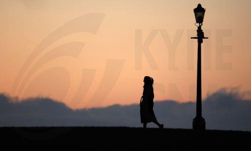 epa12539690 A woman walks as the sun rises over Primrose Hill in London, Britain, 21 November 2025. Winter weather continues across the UK, with temperatures falling below zero overnight. The Met Office has described the conditions as the 'first notable cold snap of this autumn,' bringing 'wintry hazards' and prompting the agency to issue warnings for snow...