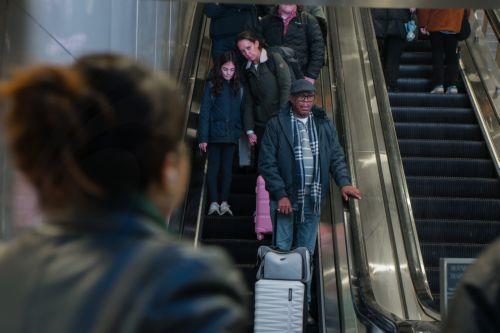 epa12549021 Travelers ride the escalator inside Moynihan Train Hall during the pre-Thanksgiving travel rush in New York, New York, USA, 25 November 2025. Penn Station and Moynihan Train Hall, which handle more than 600,000 subway, commuter rail and Amtrak riders on a typical weekday, experience significantly heavier crowds during the Thanksgiving period,...