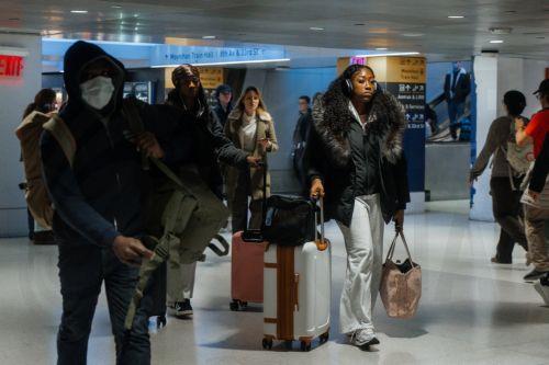 epa12549023 Travelers walk with luggage inside Moynihan Train Hall during the pre-Thanksgiving travel rush in New York, New York, USA, 25 November 2025. Penn Station and Moynihan Train Hall, which handle more than 600,000 subway, commuter rail and Amtrak riders on a typical weekday, experience significantly heavier crowds during the Thanksgiving period, the...