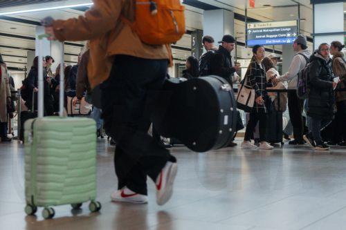 epa12549024 A traveler walks with luggage inside Moynihan Train Hall during the pre-Thanksgiving travel rush in New York, New York, USA, 25 November 2025. Penn Station and Moynihan Train Hall, which handle more than 600,000 subway, commuter rail and Amtrak riders on a typical weekday, experience significantly heavier crowds during the Thanksgiving period,...