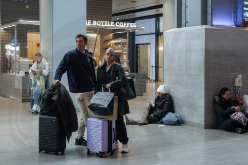 epa12549027 Travelers wait with their luggage inside Moynihan Train Hall during the pre-Thanksgiving travel rush in New York, New York, USA, 25 November 2025. Penn Station and Moynihan Train Hall, which handle more than 600,000 subway, commuter rail and Amtrak riders on a typical weekday, experience significantly heavier crowds during the Thanksgiving...