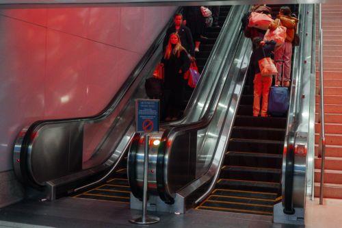 epa12549028 Travelers ride an escalator inside Moynihan Train Hall during the pre-Thanksgiving travel rush in New York, New York, USA, 25 November 2025. Penn Station and Moynihan Train Hall, which handle more than 600,000 subway, commuter rail and Amtrak riders on a typical weekday, experience significantly heavier crowds during the Thanksgiving period, the...
