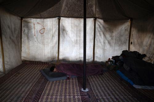 epa12562562 A displaced Palestinian rests at a temporary makeshift camp set up in Khan Younis, southern Gaza Strip, 01 December 2025, amid a ceasefire between Israel and Hamas. Around 1.9 million people in Gaza, nearly 90 percent of the population, have been displaced since the Israel-Hamas conflict began in October 2023, according to the UN.  EPA/HAITHAM...