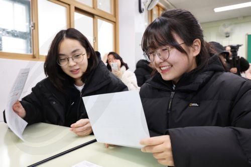 epa12570970 Seniors look at sheets showing their scores on the state-administrated scholastic aptitude test at Gwangnam High School in Seoul, South Korea, 05 December 2025. A high score on the test, administered last month, boosts a student's chances of entering their university of choice.  EPA/YONHAP / POOL SOUTH KOREA OUT