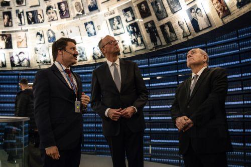 epa12576407 Dani Dayan (R), chairman of the Yad Vashem Holocaust Memorial Museum, stands with German Chancellor Friedrich Merz at the museum's Hall of Names in Jerusalem, 07 December 2025.  EPA/JOHN WESSELS / POOL