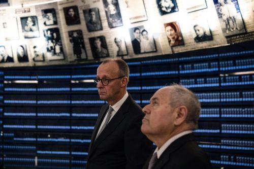 epa12576409 Dani Dayan (R), chairman of the Yad Vashem Holocaust Memorial Museum, stands with German Chancellor Friedrich Merz at the museum's Hall of Names in Jerusalem, 07 December 2025.  EPA/JOHN WESSELS / POOL