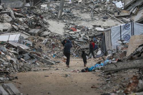 epa12578943 Internally displaced Palestinians walk among the ruins of destroyed buildings in the Al Sheikh Radwan neighborhood of Gaza City, Gaza Strip, 08 December 2025, amid a ceasefire between Israel and Hamas. Around 1.9 million people in Gaza, nearly 90 percent of the population, have been displaced since the Israel-Hamas conflict began in October...