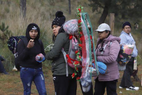 epa12581905 A woman carries a religious image during a pilgrimage to the Basilica of Guadalupe in Paso de Cortes mountain pass in Puebla state, Mexico, 09 December 2025. Hundreds of Mexican faithful began their annual pilgrimage to the Shrine of the Virgin of Guadalupe this week, which is expected to draw millions of visitors marking the 494th anniversary...